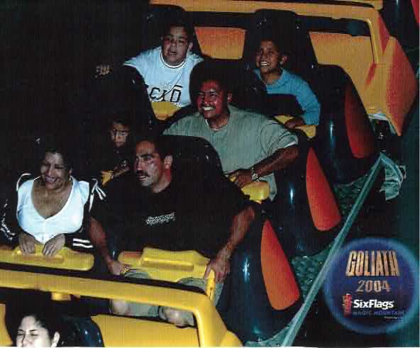 Mando as a boy laughing with family aboard a roller coaster