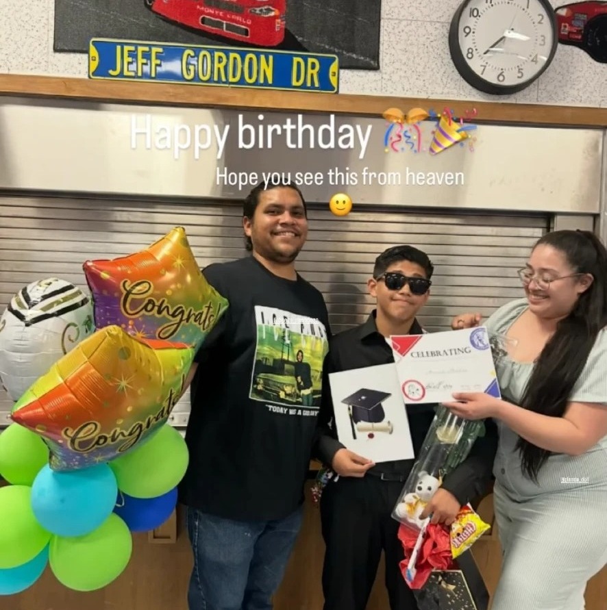 Family celebrating a graduation with colorful congrats balloons